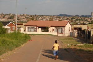A boy runs down a side street near the location of the 1976 Soweto student uprisings.